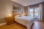 Master Bedroom on the main floor with King size bed and views of the lake out the large windows